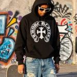 Chrome Hearts hoodie worn in urban setting, showcasing street fashion flair and luxury accessories.